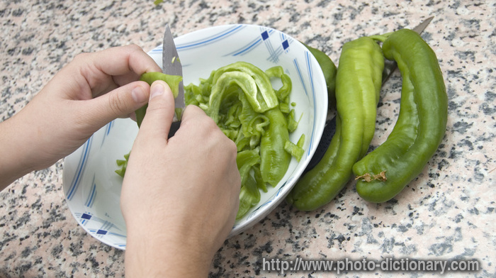 chopping peppers - photo/picture definition - chopping peppers word and phrase image