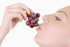 eating grapes - photo/picture definition - eating grapes word and phrase image