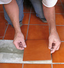 laying ceramic tile - photo/picture definition - laying ceramic tile word and phrase image